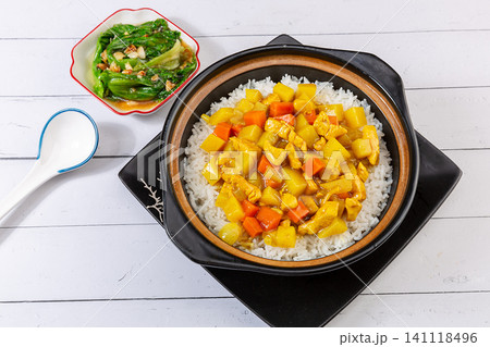 Chinese Curry Chicken Claypot Rice Casserole with Vegetables, Top View Chinese Curry Chicken Claypot Rice Casserole with Vegetables, Top View 141118496