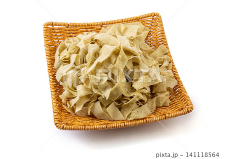 Traditional Tianjin guobacai ingredients, sliced crispy mung bean crepe ribbons on black plate Traditional Tianjin guobacai ingredients, sliced crispy mung bean crepe ribbons on black plate 141118564