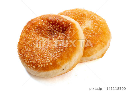 Traditional Chinese Tianjin style flaky pastry shaobing topped with white sesame seeds, isolated Traditional Chinese Tianjin style flaky pastry shaobing topped with white sesame seeds, isolated 141118590