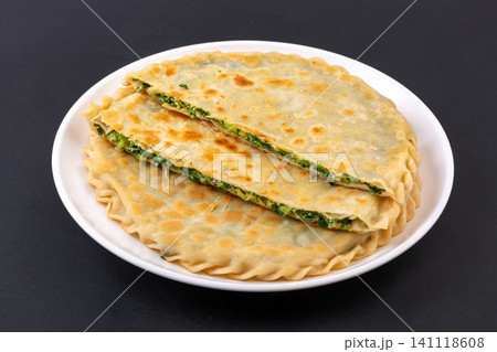 traditional Chinese Chive and Egg Stuffed Flatbread on Plate, Savory Homemade Street Food traditional Chinese Chive and Egg Stuffed Flatbread on Plate, Savory Homemade Street Food 141118608