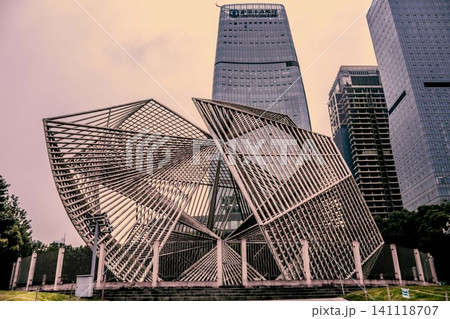 Modern metal sculpture in front of skyscrapers in Chongqing, China Modern metal sculpture in front of skyscrapers in Chongqing, China 141118707