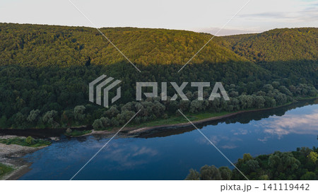 Dniester River flows through canyon landscape in Ukraine during sunset Dniester River flows through canyon landscape in Ukraine during sunset 141119442