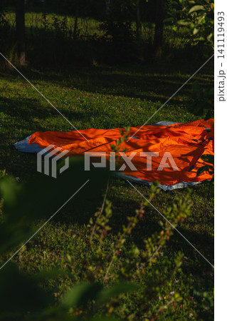 Setting up an airmattress in the backyard for summer camping fun 141119493
