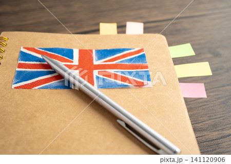 UK flag with pen on english language book. UK flag with pen on english language book. 141120906