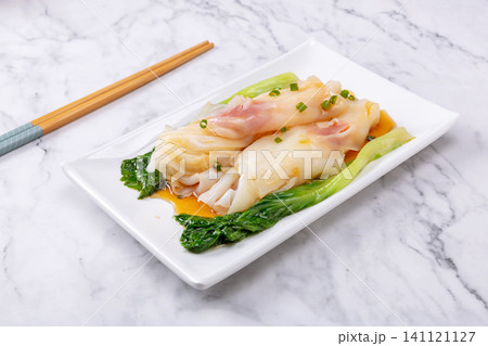 Steamed rice noodle rolls with Chinese sausage slices on plate 141121127