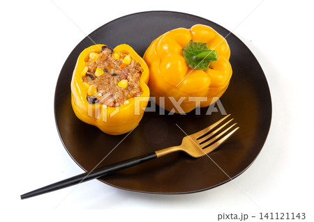 homemade stuffed bell peppers with rice and minced meat served on a plate. 141121143