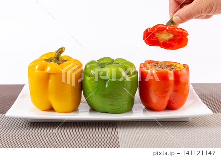 colorful roasted bell peppers stuffed with sticky rice, corn, and meat, Asian style cuisine. colorful roasted bell peppers stuffed with sticky rice, corn, and meat, Asian style cuisine. 141121147