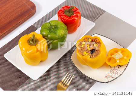 colorful roasted bell peppers stuffed with sticky rice, corn, and meat, Asian style cuisine. colorful roasted bell peppers stuffed with sticky rice, corn, and meat, Asian style cuisine. 141121148