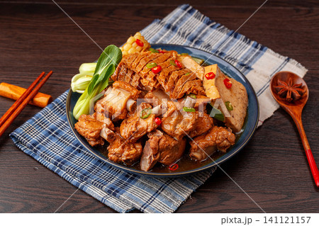 chinese traditional style braised pork ribs cooked with tofu, sweet corn and greens in a savory sauce. 141121157