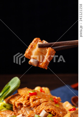 chinese traditional style braised pork ribs cooked with tofu, sweet corn and greens in a savory sauce. 141121158