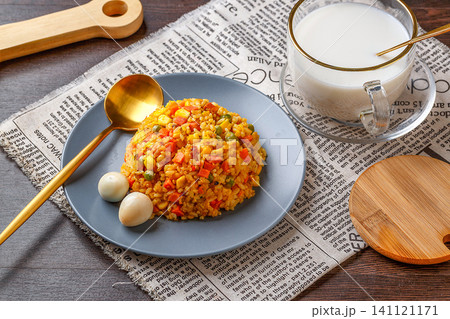chinese fried rice with green peas, sweet corn, and carrots, served with quail eggs and milk. chinese fried rice with green peas, sweet corn, and carrots, served with quail eggs and milk. 141121171