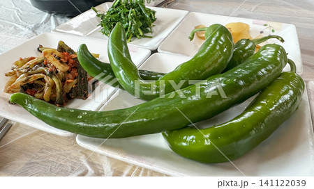 Chili peppers with side dishes on the table Chili peppers with side dishes on the table 141122039