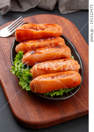grilled Taiwanese Style Premium Pork Sausages on Plate with Wooden Board 141122473