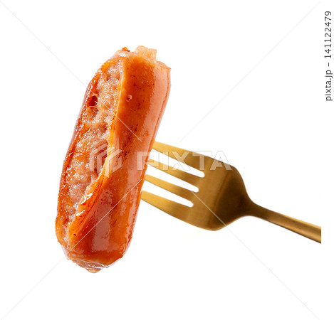 close-up of Juicy Grilled Pork Sausage on Gold Fork Isolated on White Background 141122479