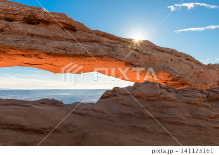 Breathtaking sunrise illuminates majestic rock arch formation in vast desert landscape of Canyonlands National Park, Utah, USA, evoking sense of wonder and natural beauty 141123161