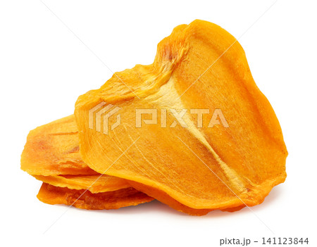 Pieces of dried persimmon close-up on a white background. Isolated Pieces of dried persimmon close-up on a white background. Isolated 141123844