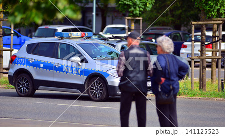 Warsaw, Poland. 6 July 2026. Policeman on a street in police car. Police sign. Warsaw, Poland. 6 July 2026. Policeman on a street in police car. Police sign. 141125523