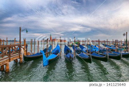 Amazing landscape with Church of San Giorgio Maggiore and gondolas parked beside the Riva degli Schiavoni in Venice Amazing landscape with Church of San Giorgio Maggiore and gondolas parked beside the Riva degli Schiavoni in Venice 141125640