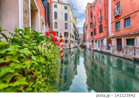 Amazing cityscape of Venice with narrow canals, boats and gondolas and bridges with traditional buildings. Amazing cityscape of Venice with narrow canals, boats and gondolas and bridges with traditional buildings. 141125642
