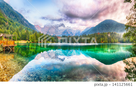 Gorgeous view of sunset over Fusine lake with Mangart peak on background. 141125661