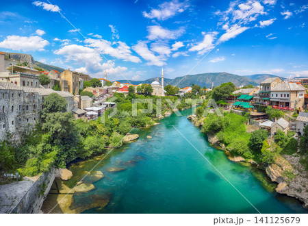 Awesome Nerteva River and Old City of Mostar, with Ottoman Mosque during sunny day Awesome Nerteva River and Old City of Mostar, with Ottoman Mosque during sunny day 141125679