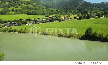green grass field and mountain with lake green grass field and mountain with lake 141127256