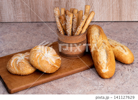 French baguettes. Fresh crispbread. Bread background. Different breed  on wooden background. 141127629