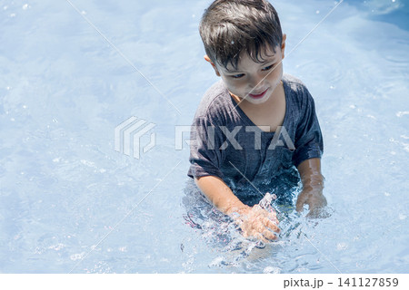 boy swimming in the pool boy swimming in the pool 141127859