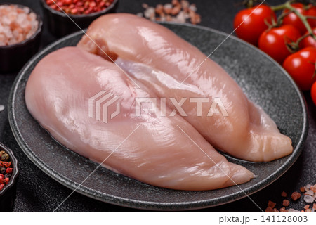 Fresh raw chicken fillet with salt and spices for home cooking. Raw chicken fillet Fresh raw chicken fillet with salt and spices for home cooking. Raw chicken fillet 141128003