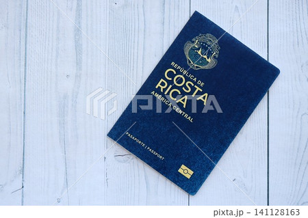 Costa Rican passport on table close up. Official identification document book for citizens of Costa Rica. Concept of travel and tourism in Costa Rica Costa Rican passport on table close up. Official identification document book for citizens of Costa Rica. Concept of travel and tourism in Costa Rica 141128163