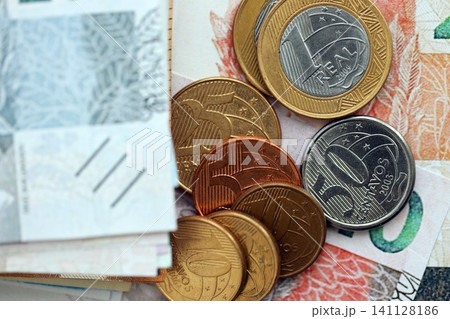 Brazilian real money bills and centavo coins pile on table. Brazil coins on banknotes of BRL currency close up. Concept of business, taxes and banking in Brazil 141128186