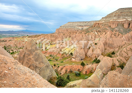 Rugged landscape with hills and valleys in Cappadocia region during daytime Rugged landscape with hills and valleys in Cappadocia region during daytime 141128260