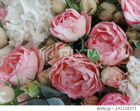 Soft pink peonies, white carnations, cream spray roses and eucalyptus in a romantic floral bouquet. Close-up of fresh blooming flowers with delicate petals, pastel colors, natural light, elegant Soft pink peonies, white carnations, cream spray roses and eucalyptus in a romantic floral bouquet. Close-up of fresh blooming flowers with delicate petals, pastel colors, natural light, elegant 141128271