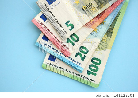 Big amount of european euro currency money notes on blue color table close up 141128301