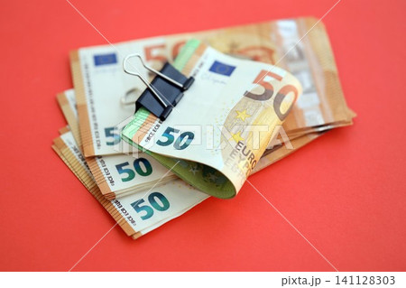 Big amount of european euro currency money notes on red color table close up Big amount of european euro currency money notes on red color table close up 141128303