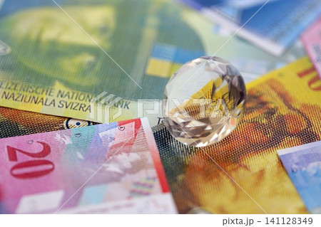 Swiss franc banknotes and diamond. The current francs money bills and gem lies on table 141128349