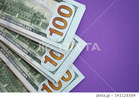 Big amount of United States hundred dollar bills on purple background 141128384