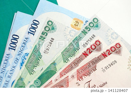 Nigerian naira currency money bills lies on flag. The concept of business and investment Nigerian naira currency money bills lies on flag. The concept of business and investment 141128407