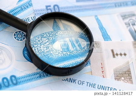 United Arab Emirates dirham currency money bills and magnifying glass. The concept of financial monitoring and taxation United Arab Emirates dirham currency money bills and magnifying glass. The concept of financial monitoring and taxation 141128417