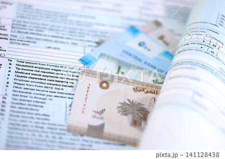 United Arab Emirates dirham money bills on tax form. Taxation and accounting concept United Arab Emirates dirham money bills on tax form. Taxation and accounting concept 141128438