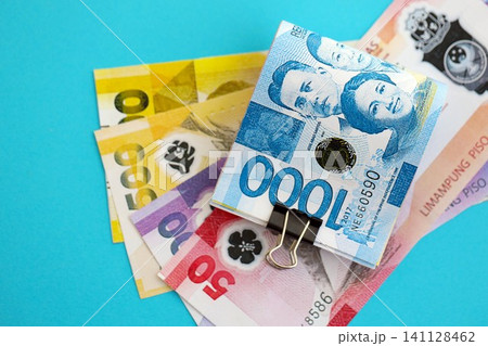 Philippines peso money bills in big amount on blue. Finance and banking concept 141128462