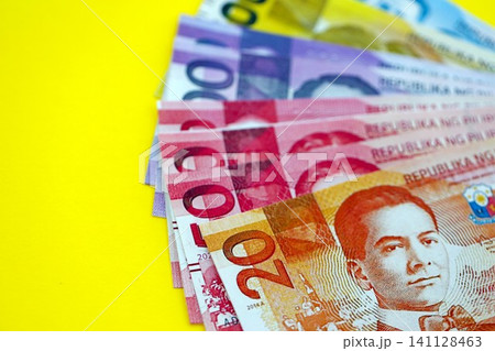 Philippines peso money bills in big amount on yellow. Finance and banking concept Philippines peso money bills in big amount on yellow. Finance and banking concept 141128463
