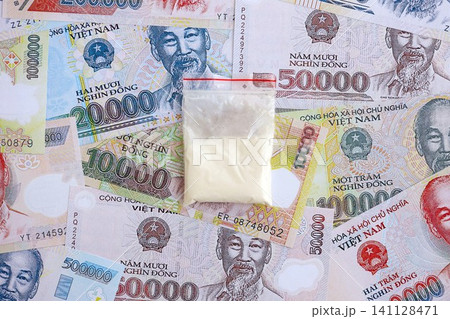 Vietnamese dong currency money bills and cocaine pack. The concept of drug trafficking Vietnamese dong currency money bills and cocaine pack. The concept of drug trafficking 141128471