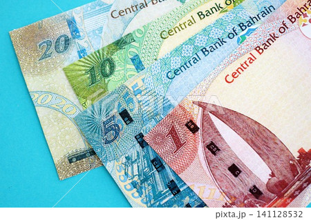 Bahraini dinar money bills in big amount on blue. Finance and banking concept Bahraini dinar money bills in big amount on blue. Finance and banking concept 141128532