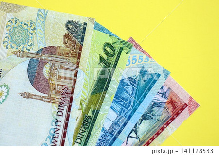 Bahraini dinar money bills in big amount on yellow. Finance and banking concept Bahraini dinar money bills in big amount on yellow. Finance and banking concept 141128533