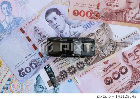 Thai baht currency money bills and toy car. The concept of car ownership Thai baht currency money bills and toy car. The concept of car ownership 141128548