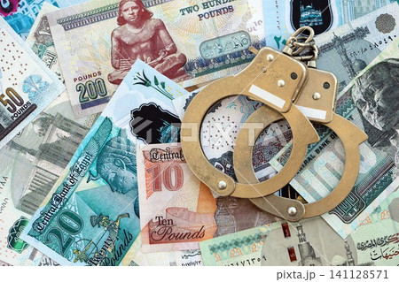 Egyptian pound currency money bills and handcuffs. The concept of criminal 141128571