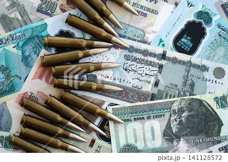 Egyptian pound currency money bills and rifle bullets. The concept of warfare and gun selling 141128572