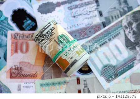 Egyptian pound currency money bills and bunch of us dollars. The concept of currency exchange Egyptian pound currency money bills and bunch of us dollars. The concept of currency exchange 141128578