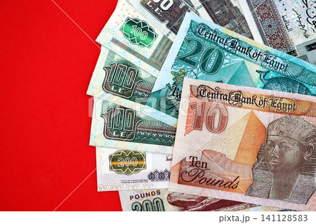 Egyptian pound money bills in big amount on red. Finance and banking concept Egyptian pound money bills in big amount on red. Finance and banking concept 141128583
